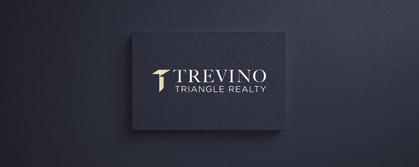 Dark Trevino Realty business cards with gold logo details