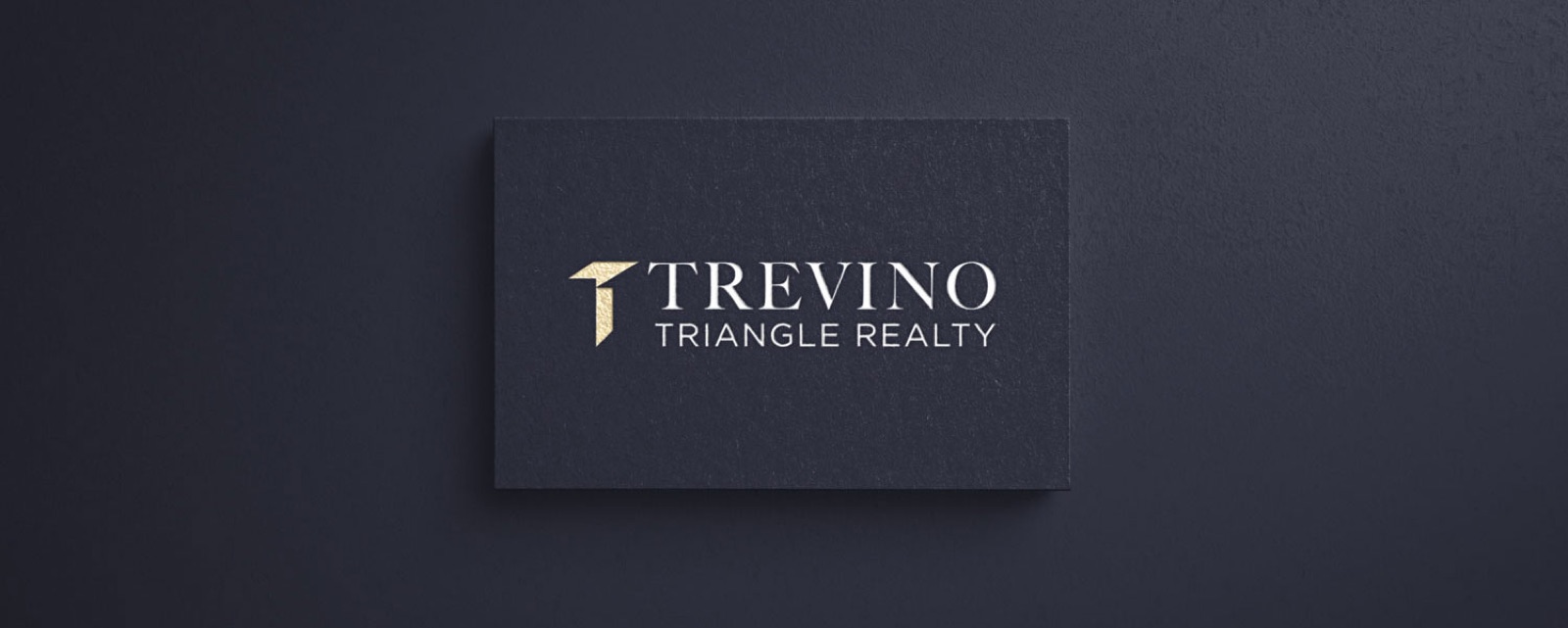Dark Trevino Realty business cards with gold logo details